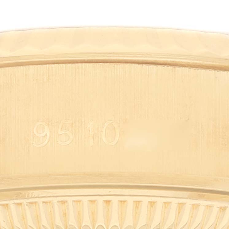 This image shows a close-up of the edge of a Rolex President 69178 Women's Yellow Gold Champagne Dial 69178 Women's Yellow Gold Champagne Dial model watch, focusing on the serial number engraving.