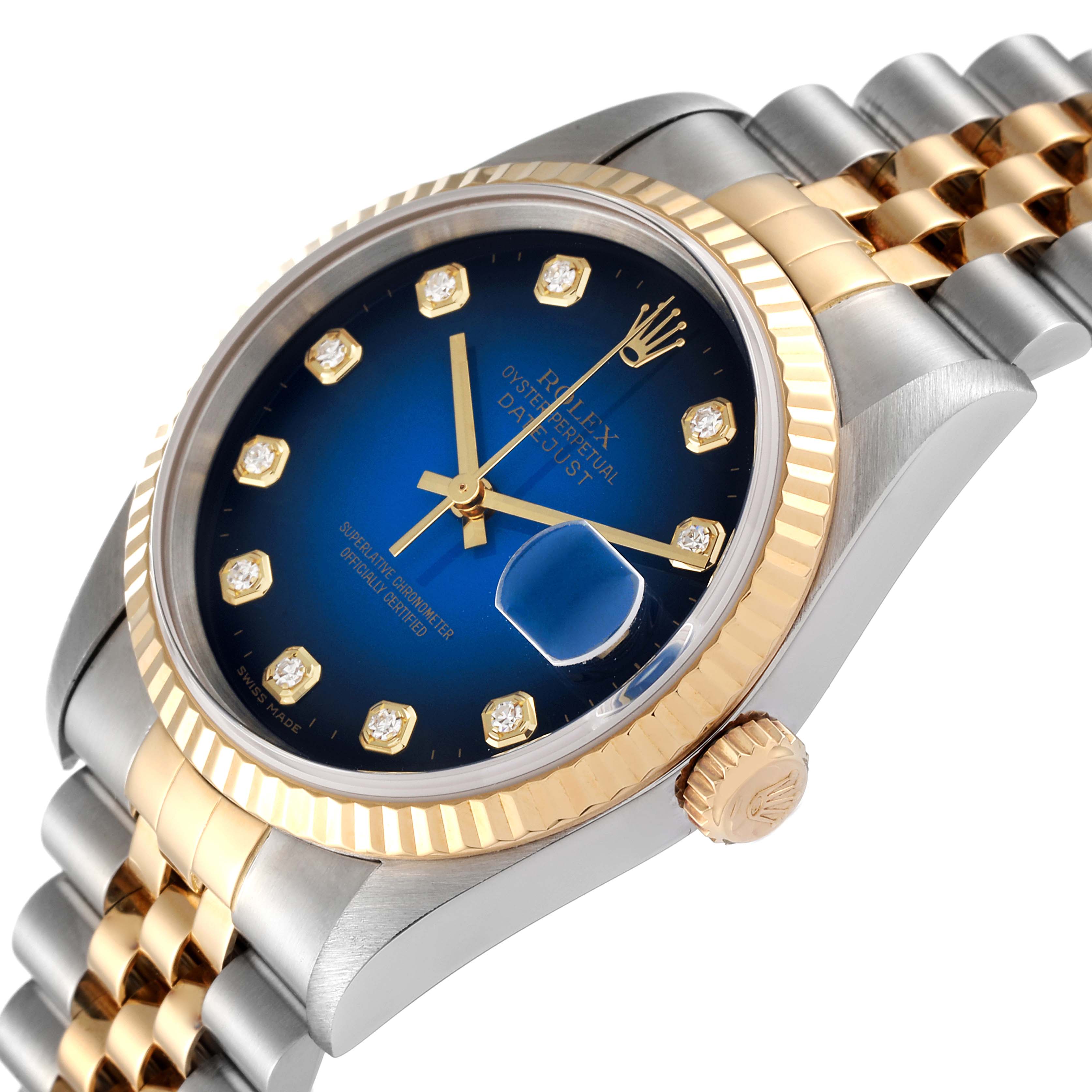 This angled close-up photo shows the dial, fluted bezel, crown, and part of the Jubilee bracelet of a Rolex Datejust 16233 Men's Steel and Gold (two tone) Blue Dial 16233 Men's Steel and Gold (two tone) Blue Dial watch.