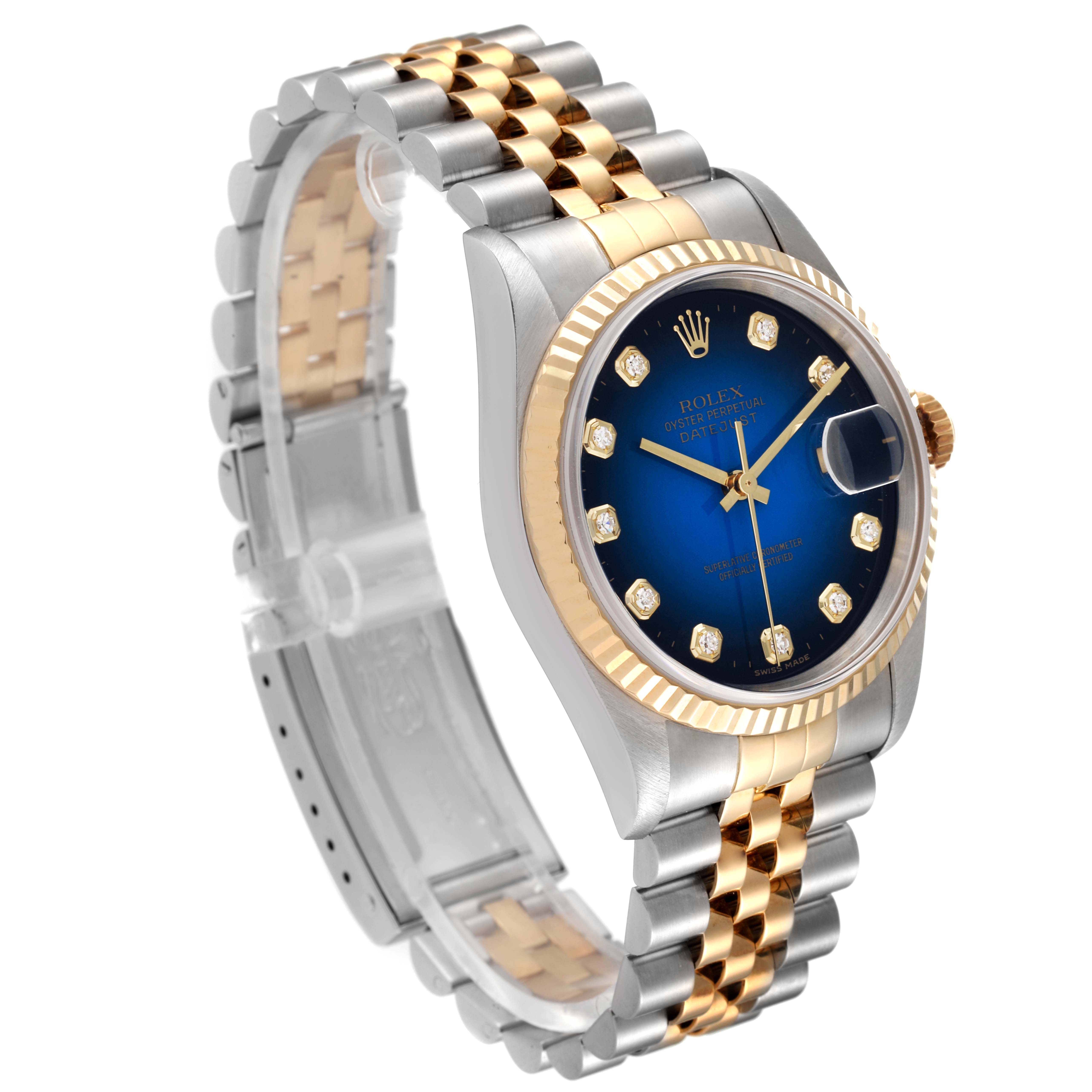 The image shows a Rolex Datejust 16233 Men's Steel and Gold (two tone) Blue Dial 16233 Men's Steel and Gold (two tone) Blue Dial watch at a slight angle, highlighting its blue dial, fluted bezel, and two-tone bracelet.