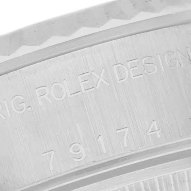 The image shows a close-up of the engraved caseback or inner rim of a Rolex Datejust 79174 Women
s Stainless Steel Mother of Pearl Dial 79174 Women
s Stainless Steel Mother of Pearl Dial.