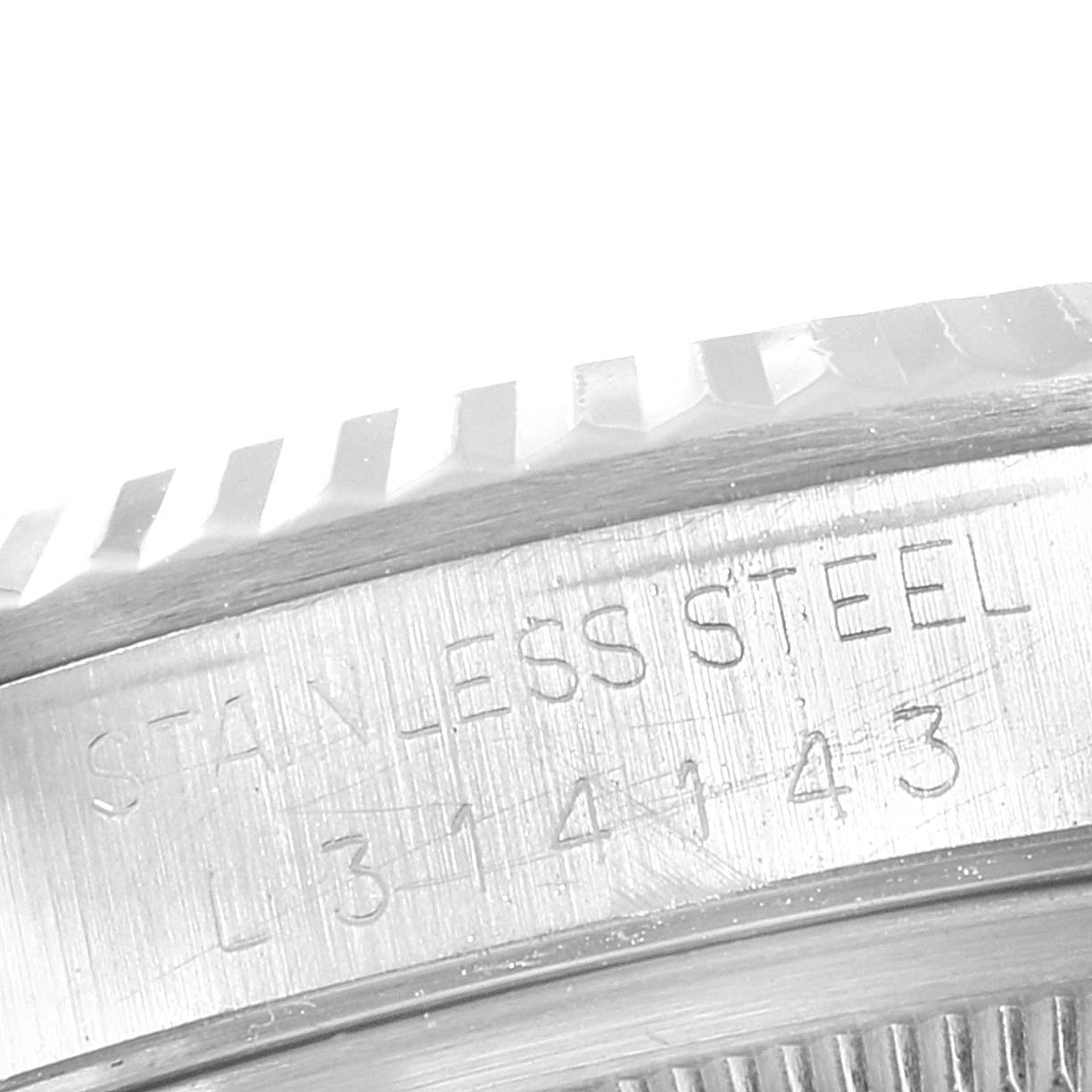 This image shows a close-up of the fluted bezel and the engraved case of the Rolex Datejust 16234 Men's Stainless Steel Silver Dial 16234 Men's Stainless Steel Silver Dial watch, identifying it as stainless steel.