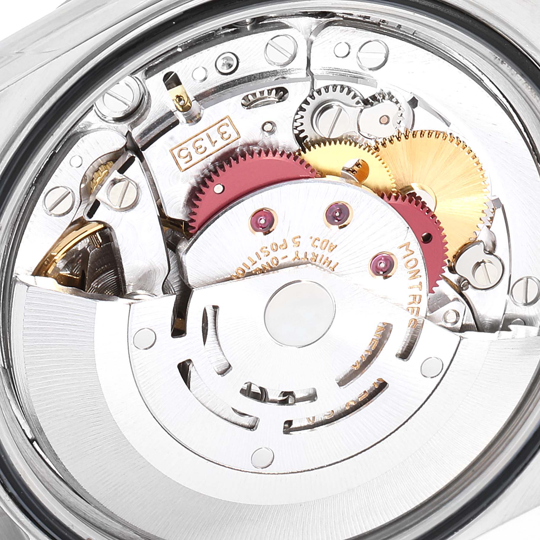 The image shows a close-up view of the movement mechanism of a Rolex Datejust 16234 Men's Stainless Steel Silver Dial 16234 Men's Stainless Steel Silver Dial watch, highlighting its gears and components.