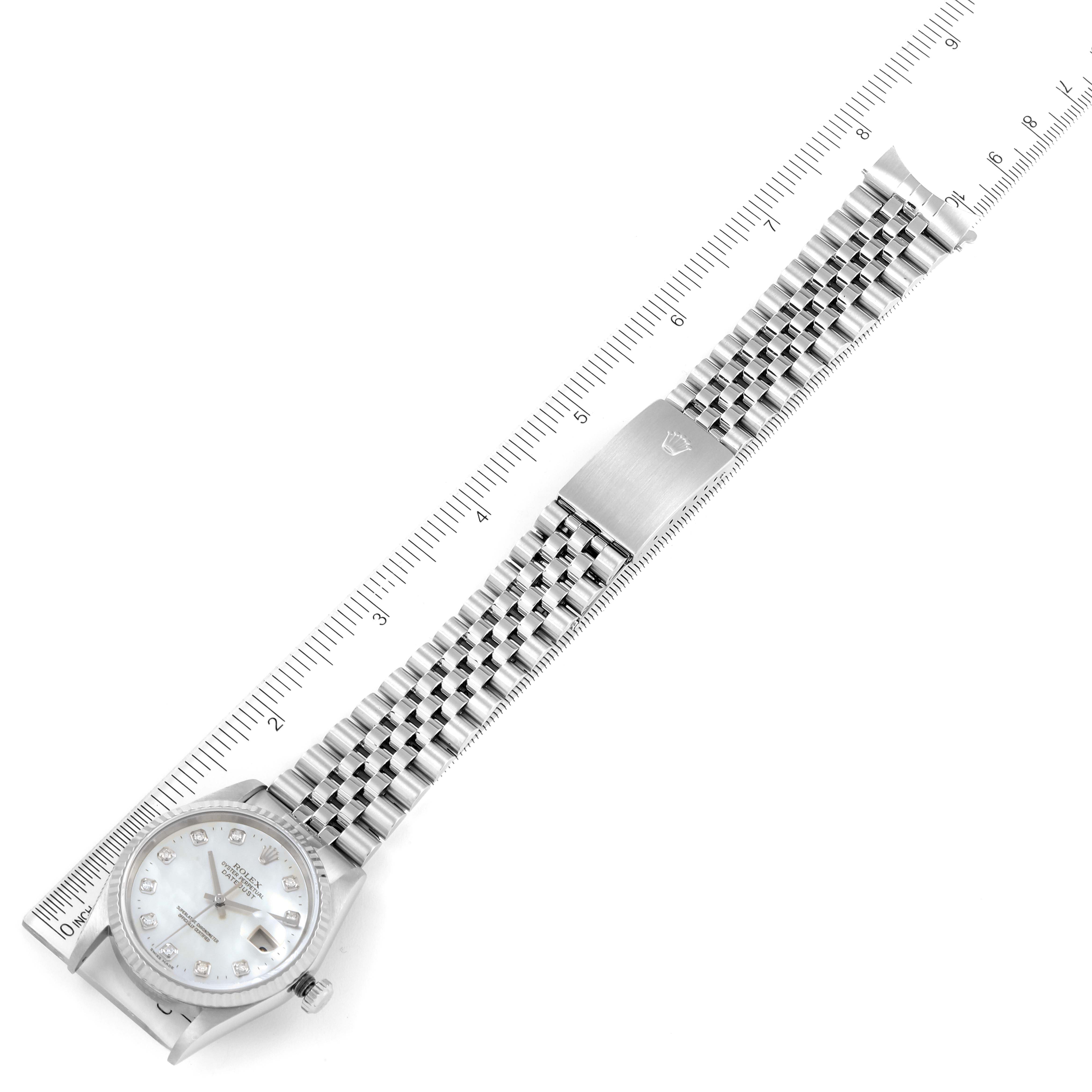 The image shows a Rolex Datejust 16234 Men's Stainless Steel Mother of Pearl Dial 16234 Men's Stainless Steel Mother of Pearl Dial watch laid flat with a metal bracelet and a ruler for scale.