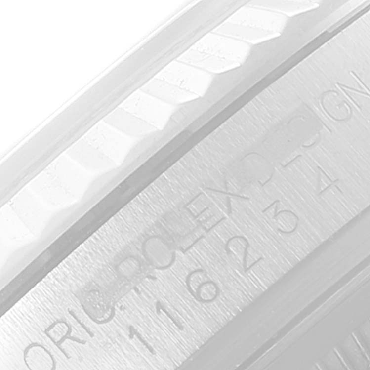 The image shows a close-up of the engraved inner bezel and fluted bezel of the Rolex Datejust 116234 Men's Stainless Steel White Dial 116234 Men's Stainless Steel White Dial watch.