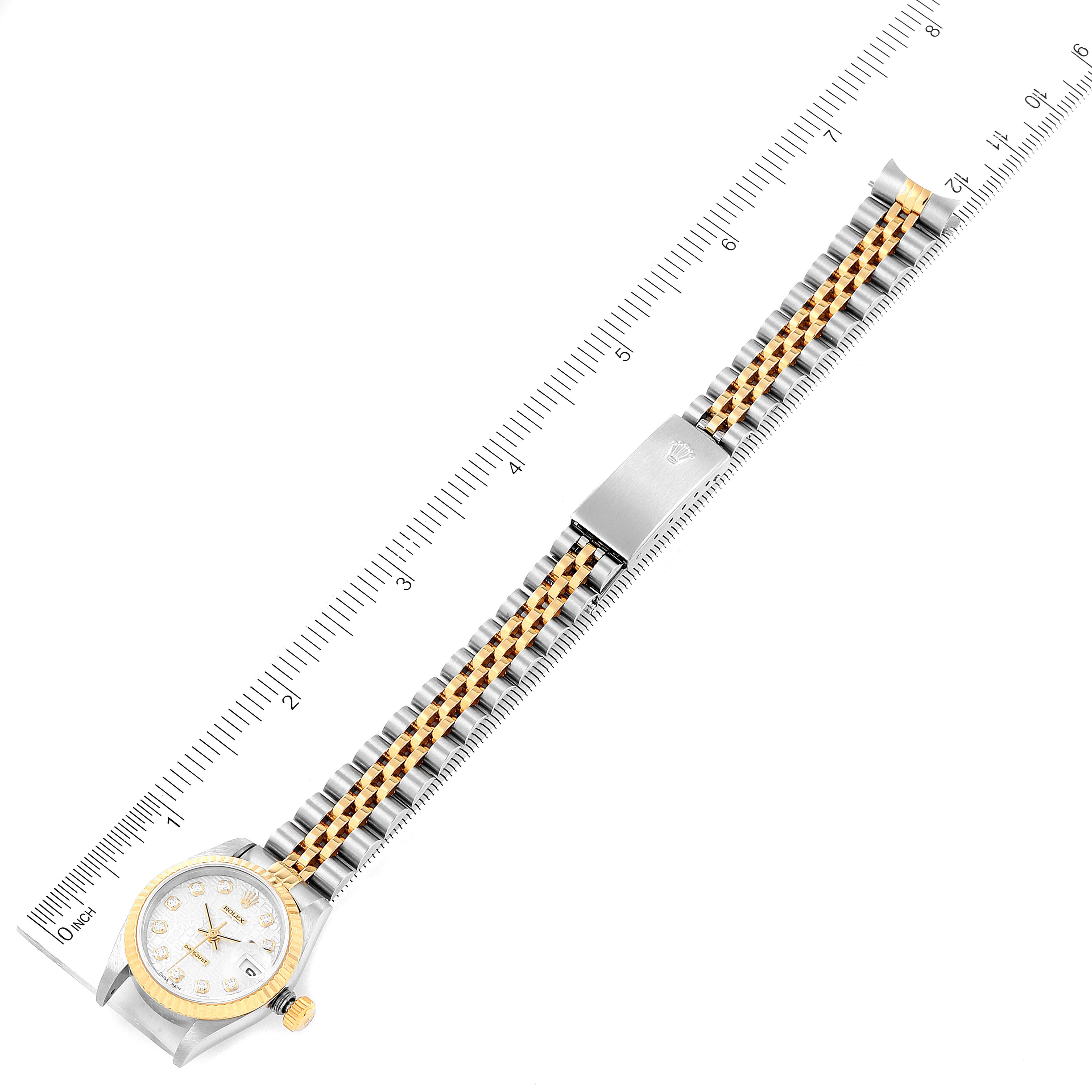 The image shows a top-down view of a Rolex Datejust 69173 Women
s Steel and Gold (two tone) Silver Dial 69173 Women
s Steel and Gold (two tone) Silver Dial watch, highlighting the face, bezel, and two-tone metal bracelet with a ruler for scale.