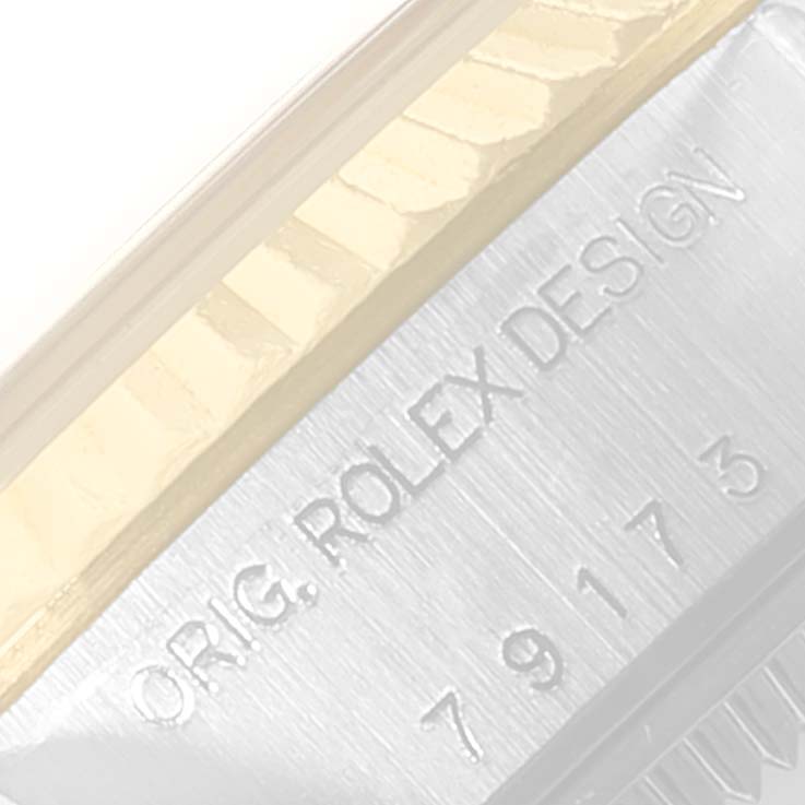 This close-up image shows the side engraving of a Rolex Datejust 69173 Women
s Steel and Gold (two tone) Silver Dial 69173 Women
s Steel and Gold (two tone) Silver Dial watch, specifically the "ORIG. ROLEX DESIGN" text.