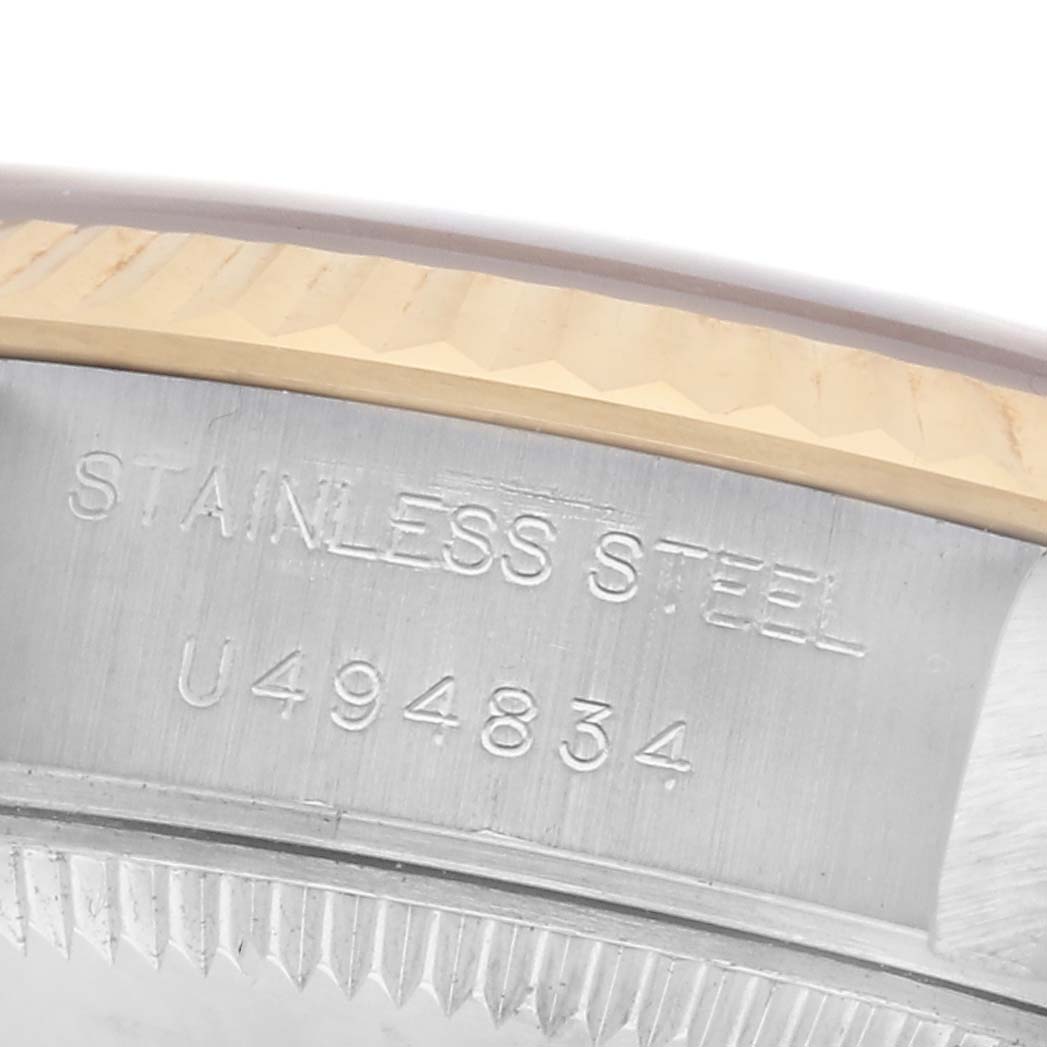 The image shows a close-up of the serial number on the side of the case of a Rolex Datejust 69173 Women's Steel and Gold (two tone) Champagne Dial 69173 Women's Steel and Gold (two tone) Champagne Dial watch.