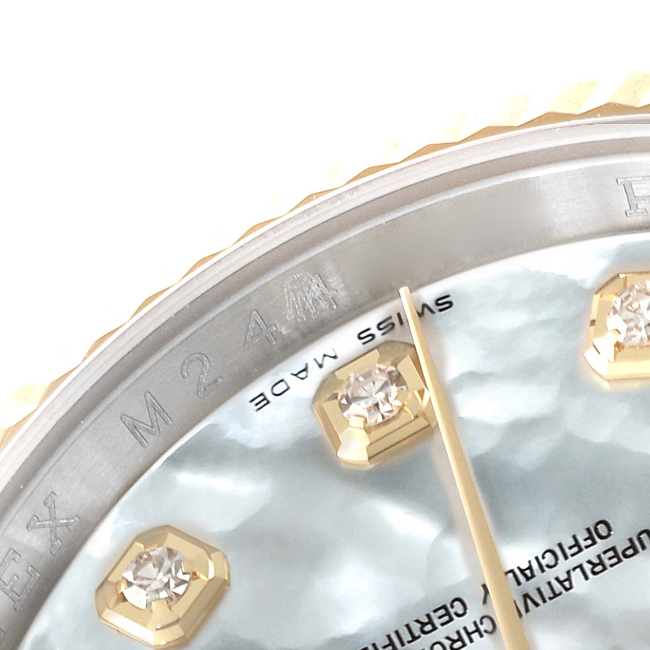 This close-up image shows part of the dial with diamond markers and the brushed metal bezel edge of the Rolex Datejust 116233 Men's Steel and Gold (two tone) Mother of Pearl Dial 116233 Men's Steel and Gold (two tone) Mother of Pearl Dial model.