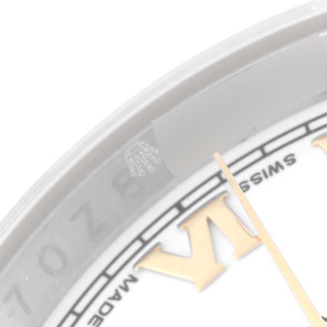 This close-up image shows part of the dial and the bezel of the Rolex Datejust 116233 Men's Steel and Gold (two tone) White Dial 116233 Men's Steel and Gold (two tone) White Dial watch.