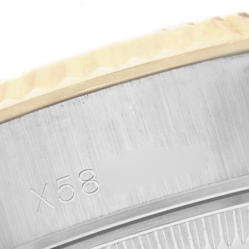 The image shows a close-up of the side of the case and bezel of a Rolex Datejust 69173 Women
s Steel and Gold (two tone) White Dial 69173 Women
s Steel and Gold (two tone) White Dial, highlighting its fluted bezel detail.