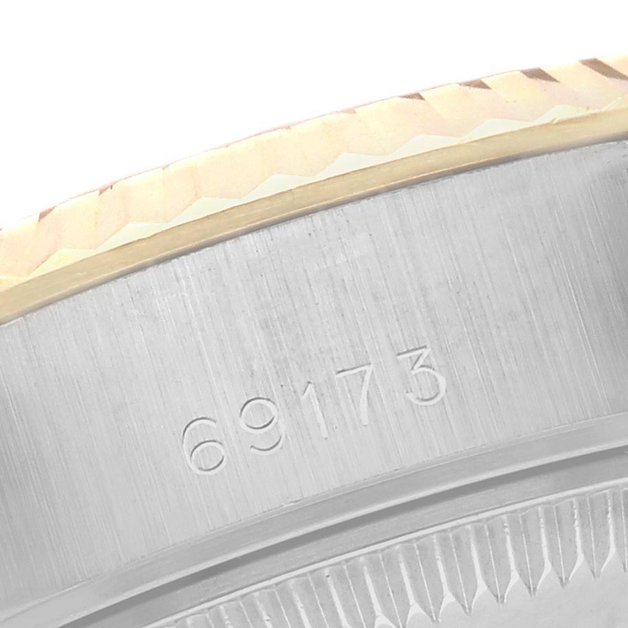 The image shows a close-up of the Rolex Datejust 69173 Women
s Steel and Gold (two tone) White Dial 69173 Women
s Steel and Gold (two tone) White Dial
s fluted bezel and part of the case, displaying the model number 69173.