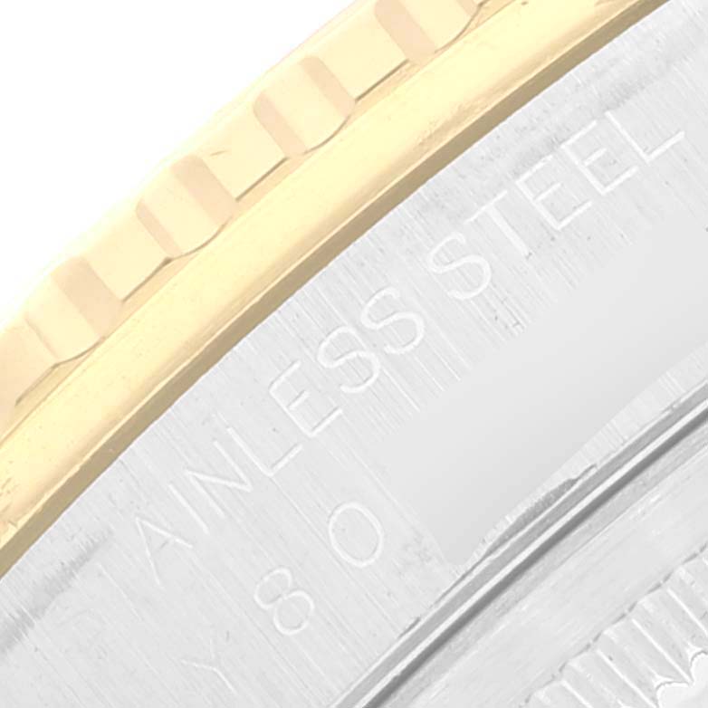 This is a close-up of the Rolex Turn-o-Graph 16263 Men
s Steel and Gold (two tone) Black Dial 16263 Men
s Steel and Gold (two tone) Black Dial watch, showing the stainless steel case back with engraved text and the edge of the bezel.