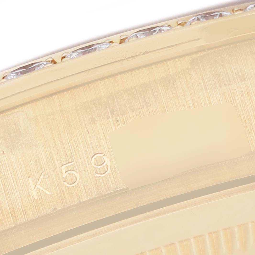 This is a close-up shot of the bezel and serial number of a Rolex Pearlmaster 18948 Men's Yellow Gold Mother of Pearl Dial 18948 Men's Yellow Gold Mother of Pearl Dial watch, showing part of the engraved detail and diamonds.
