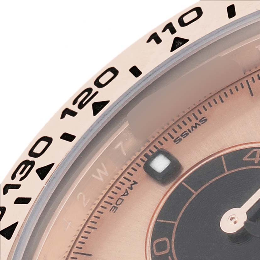 The image shows a close-up view of the bezel and part of the dial on a Rolex Daytona 116505 Men's Rose Gold Pink Dial watch.