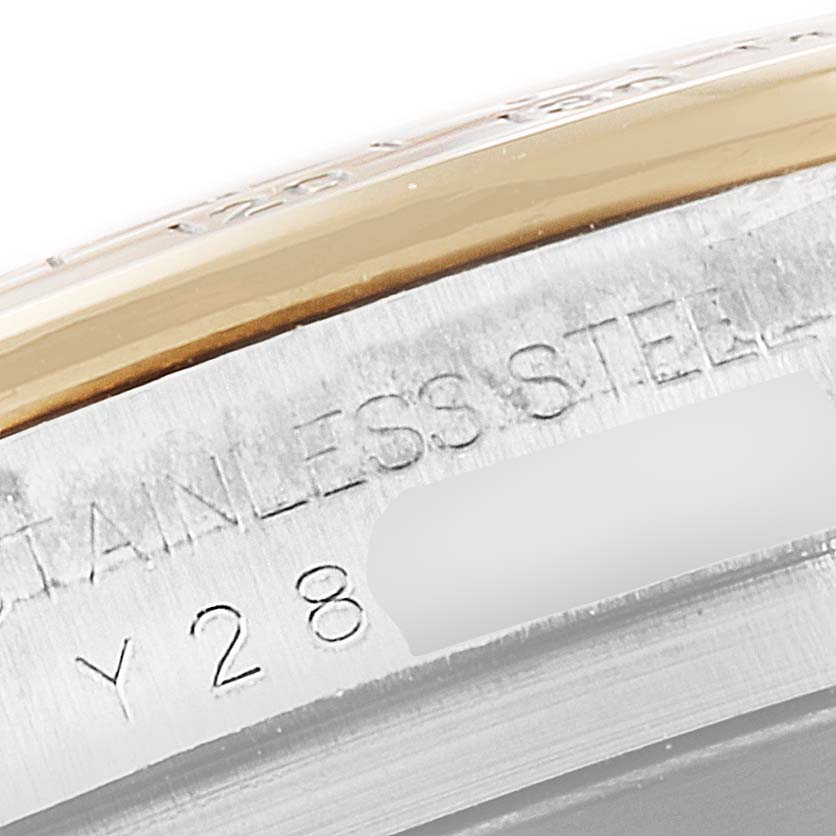 This image shows a close-up of the engraving on the side of the bezel and case of a Rolex Daytona 116523 Men
s Steel and Gold (two tone) White Dial 116523 Men
s Steel and Gold (two tone) White Dial watch.