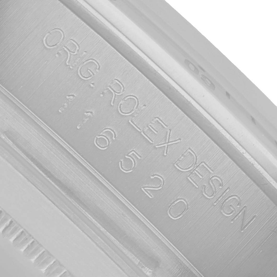 The image shows a close-up of the case side engraving on a Rolex Daytona 116520 Men's Stainless Steel White Dial watch.