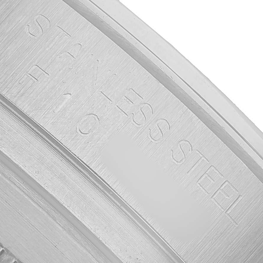 The image shows a close-up of the inner case of a Rolex Daytona 116520 Men's Stainless Steel White Dial, highlighting etched text details.