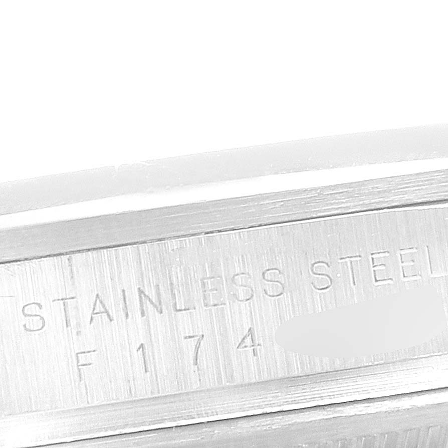 The image shows a close-up of the inscription on the stainless steel case of a Rolex Explorer 114270 Men's Stainless Steel Black Dial 114270 Men's Stainless Steel Black Dial watch.