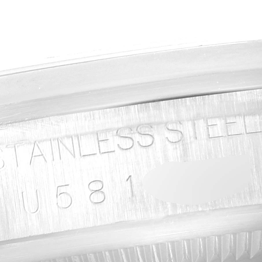 The image shows a close-up angle of the serial number and "STAINLESS STEEL" inscription on a Rolex Explorer 14270 Men
s Stainless Steel Black Dial 14270 Men
s Stainless Steel Black Dial model watch.