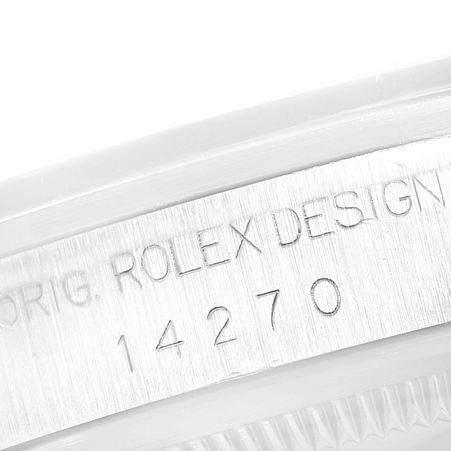 This close-up image shows the Rolex Explorer 14270 Men
s Stainless Steel Black Dial 14270 Men
s Stainless Steel Black Dial model
s case side with "ROLEX DESIGN" and serial number 14270 engraved.