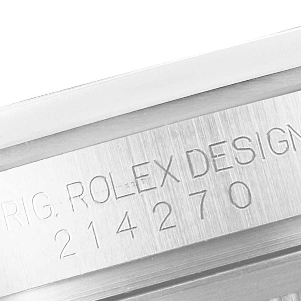The image shows the engraved serial number and "ROLEX DESIGN" on the side of the case of a Rolex Explorer 214270 Men
s Stainless Steel Black Dial 214270 Men
s Stainless Steel Black Dial watch.