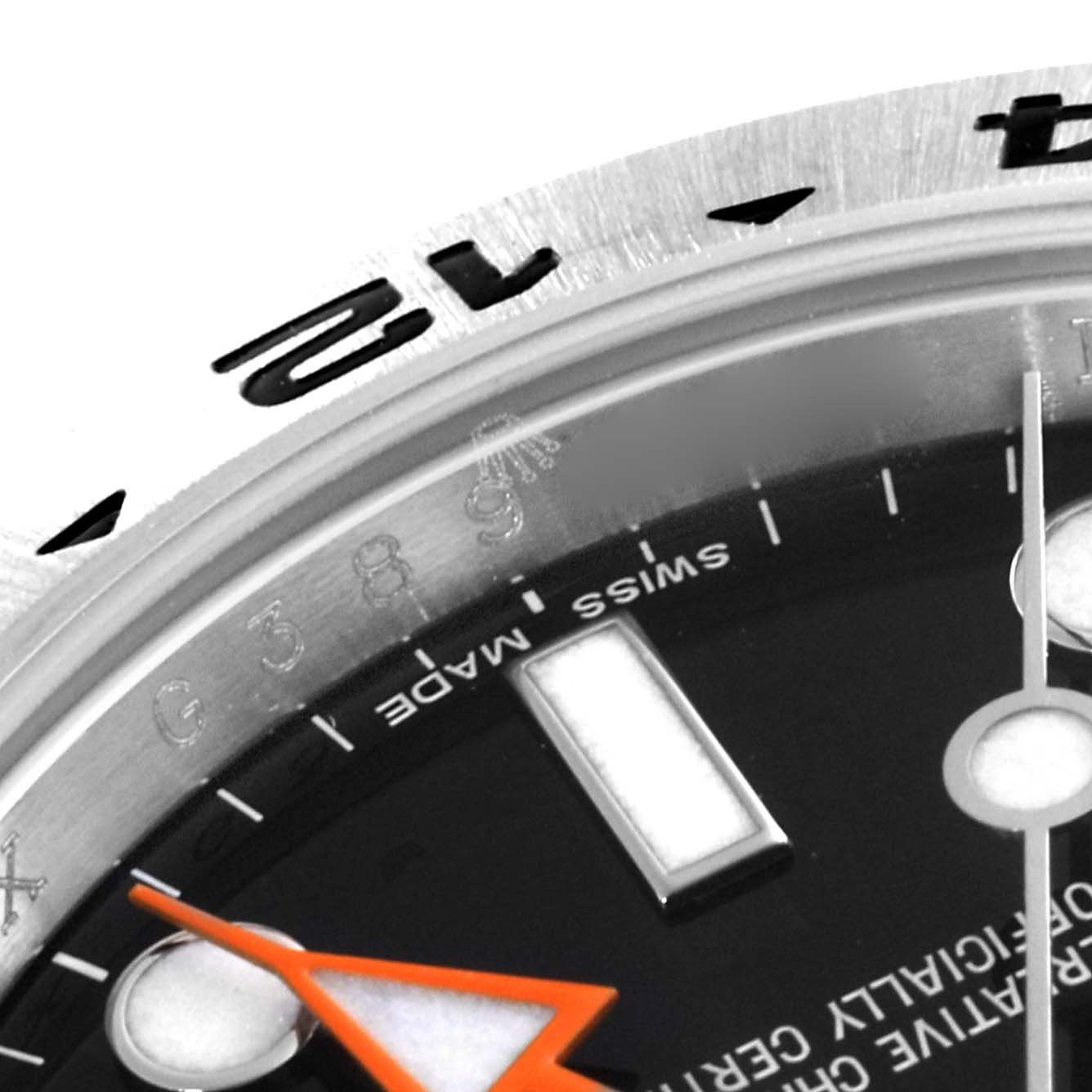 The image shows a close-up of the dial and bezel of a Rolex Explorer 216570 Men's Stainless Steel Black Dial 216570 Men's Stainless Steel Black Dial watch, focusing on the 12 o'clock position and minute markers.