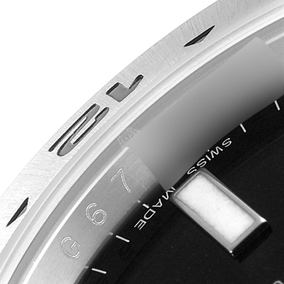 This image shows a close-up view of a portion of the dial and bezel of a Rolex Explorer 216570 Men's Stainless Steel Black Dial 216570 Men's Stainless Steel Black Dial watch.