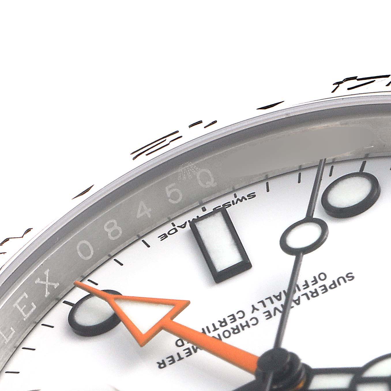 This is a close-up view of a Rolex Explorer 216570 Men's Stainless Steel White Dial 216570 Men's Stainless Steel White Dial watch, showing parts of the dial, hour markers, and part of the bezel.
