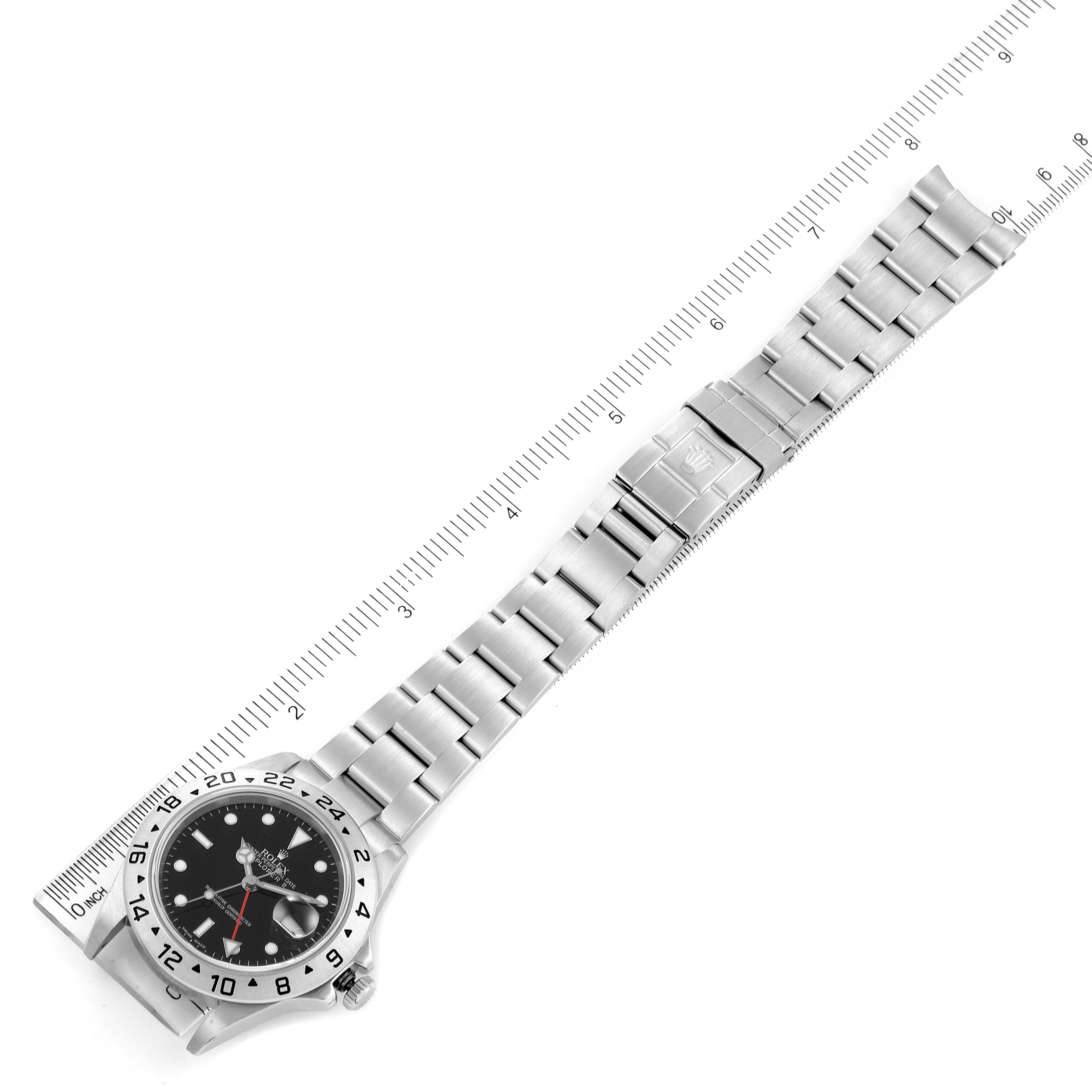 The image shows a Rolex Explorer 16570 Men
s Stainless Steel Black Dial 16570 Men
s Stainless Steel Black Dial watch laid flat with a ruler alongside, displaying the watch case, dial, and metal bracelet.