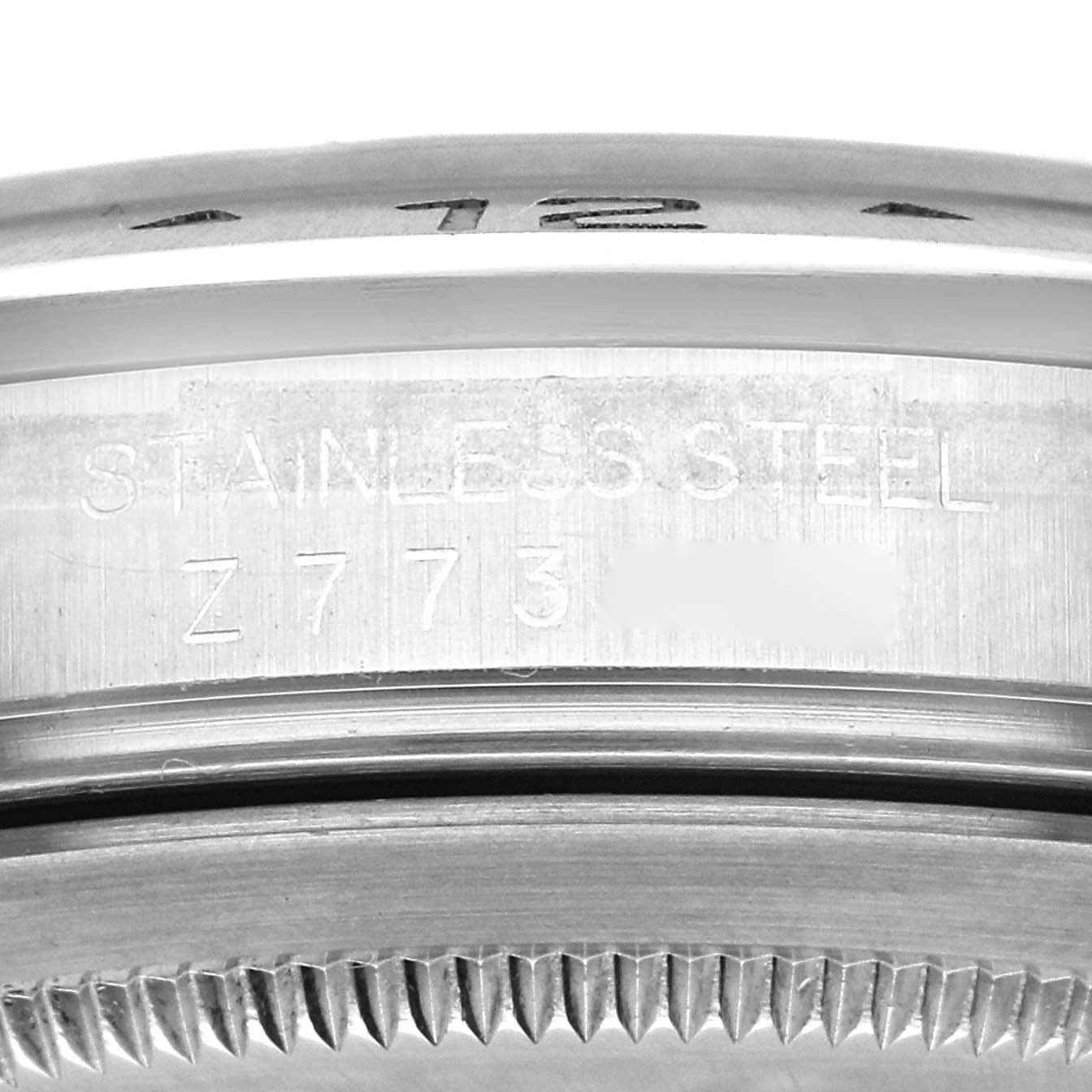 This close-up image of the Rolex Explorer 16570T Men
s Stainless Steel Black Dial 16570T Men
s Stainless Steel Black Dial watch shows the stainless steel case and part of the engraved bezel.