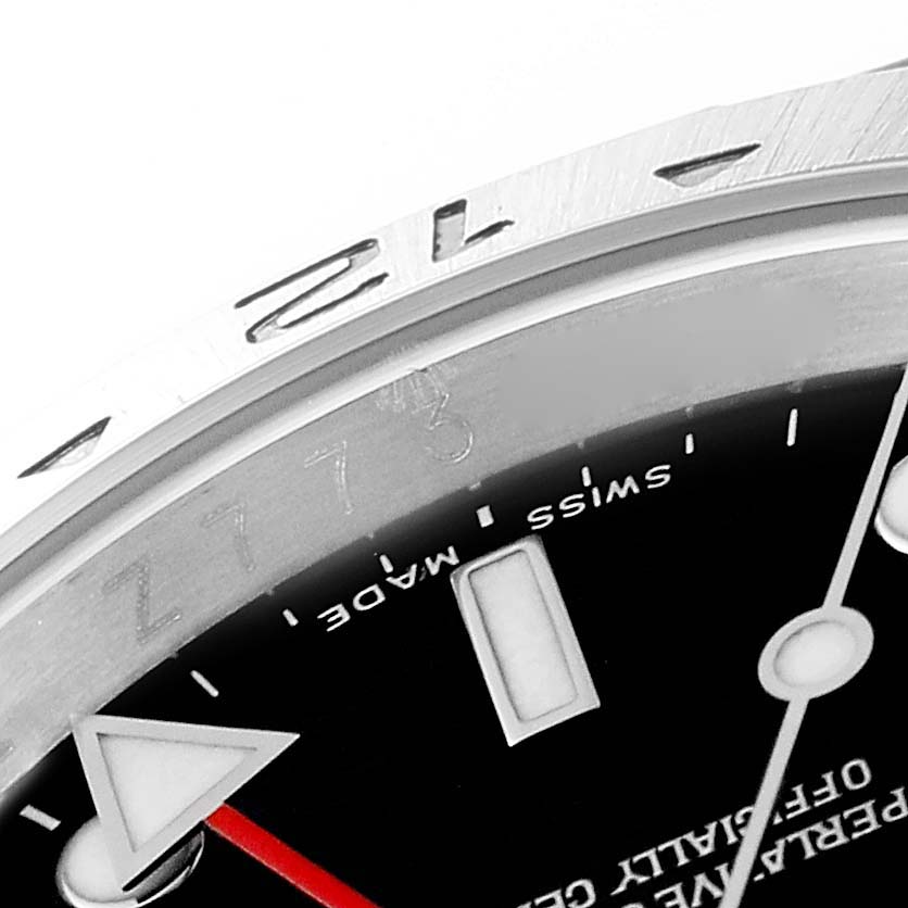 The image shows a close-up of the dial and bezel of a Rolex Explorer 16570T Men
s Stainless Steel Black Dial 16570T Men
s Stainless Steel Black Dial watch, highlighting the 12 o
clock marker and the "Swiss Made" text.