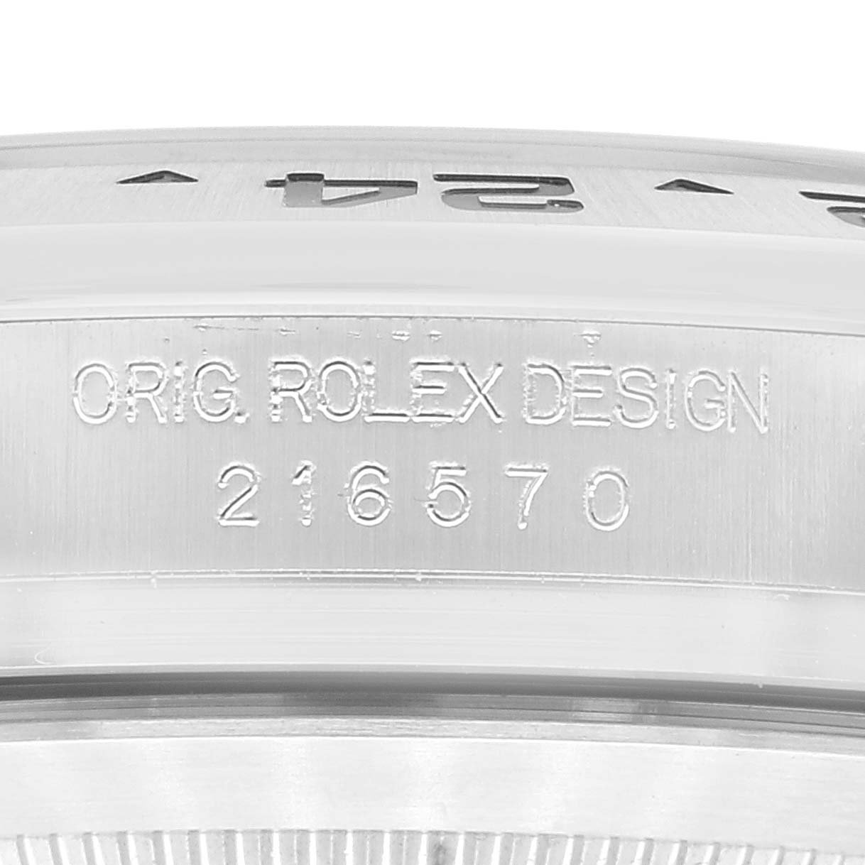 The image shows a close-up of the engraved bezel and case of a Rolex Explorer 216570 Men
s Stainless Steel Black Dial 216570 Men
s Stainless Steel Black Dial model, with the model number 216570 visible.
