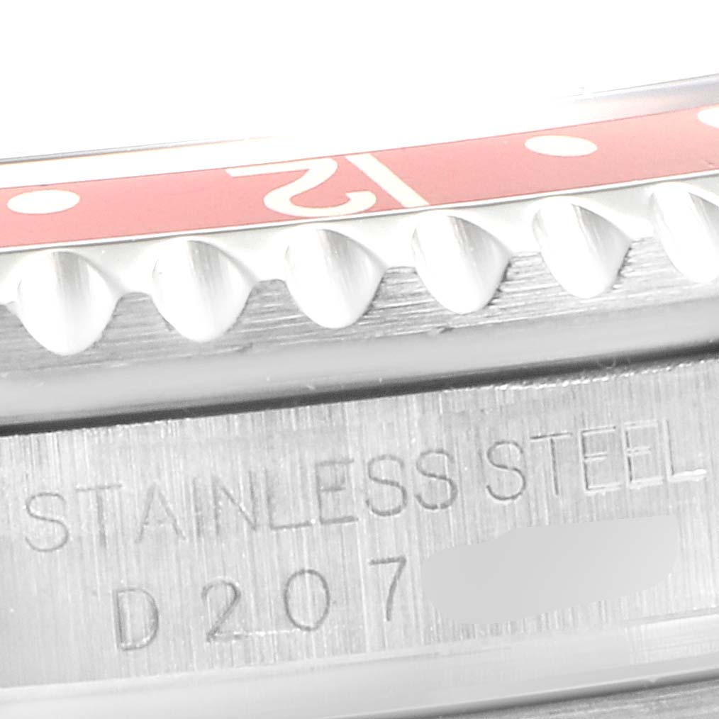 The image shows a close-up of the stainless steel case and red bezel of a Rolex GMT-Master 16710 Men
s Stainless Steel Black Dial 16710 Men
s Stainless Steel Black Dial watch.