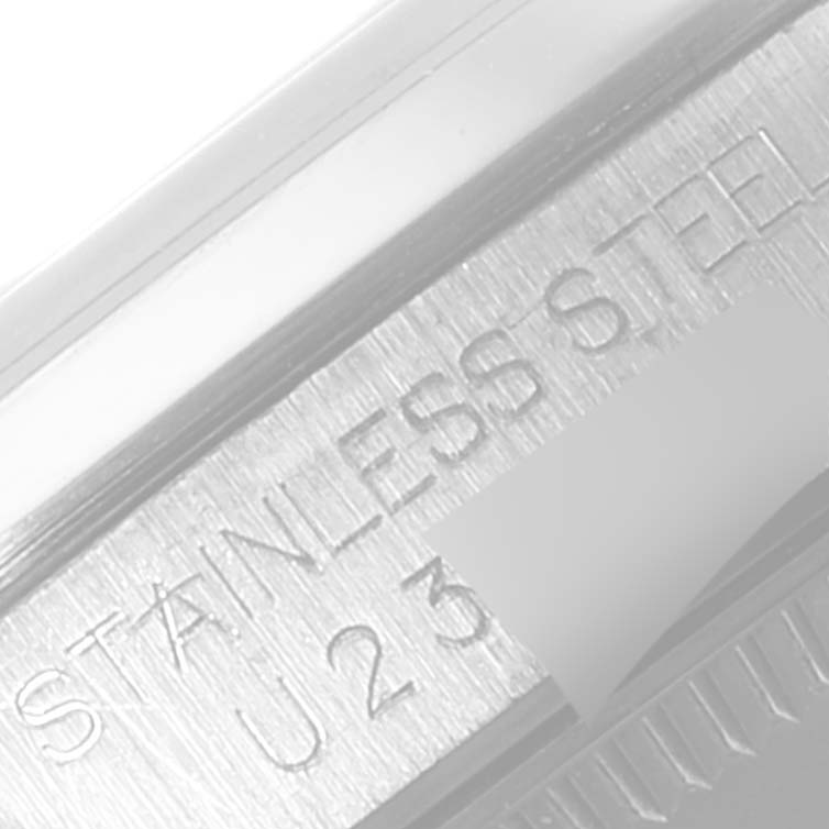 This image shows a close-up of the case back of a Rolex Mid-Size 67480 Women's Stainless Steel Blue Dial 67480 Women's Stainless Steel Blue Dial model, specifically highlighting the "Stainless Steel" engraving.