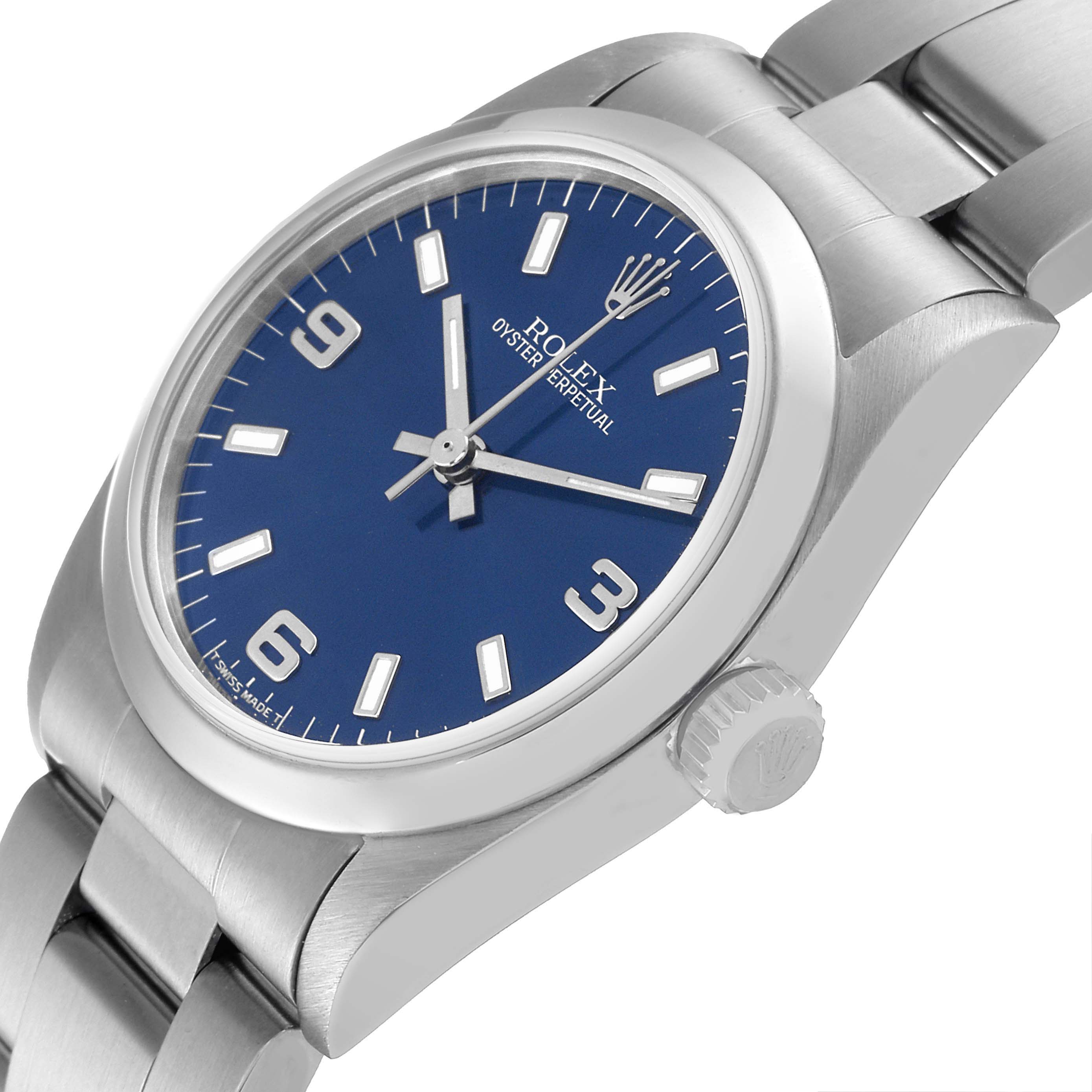 This image shows a close-up view of the Rolex Mid-Size 67480 Women's Stainless Steel Blue Dial 67480 Women's Stainless Steel Blue Dial Oyster Perpetual watch, highlighting the dial, crown, and bracelet.