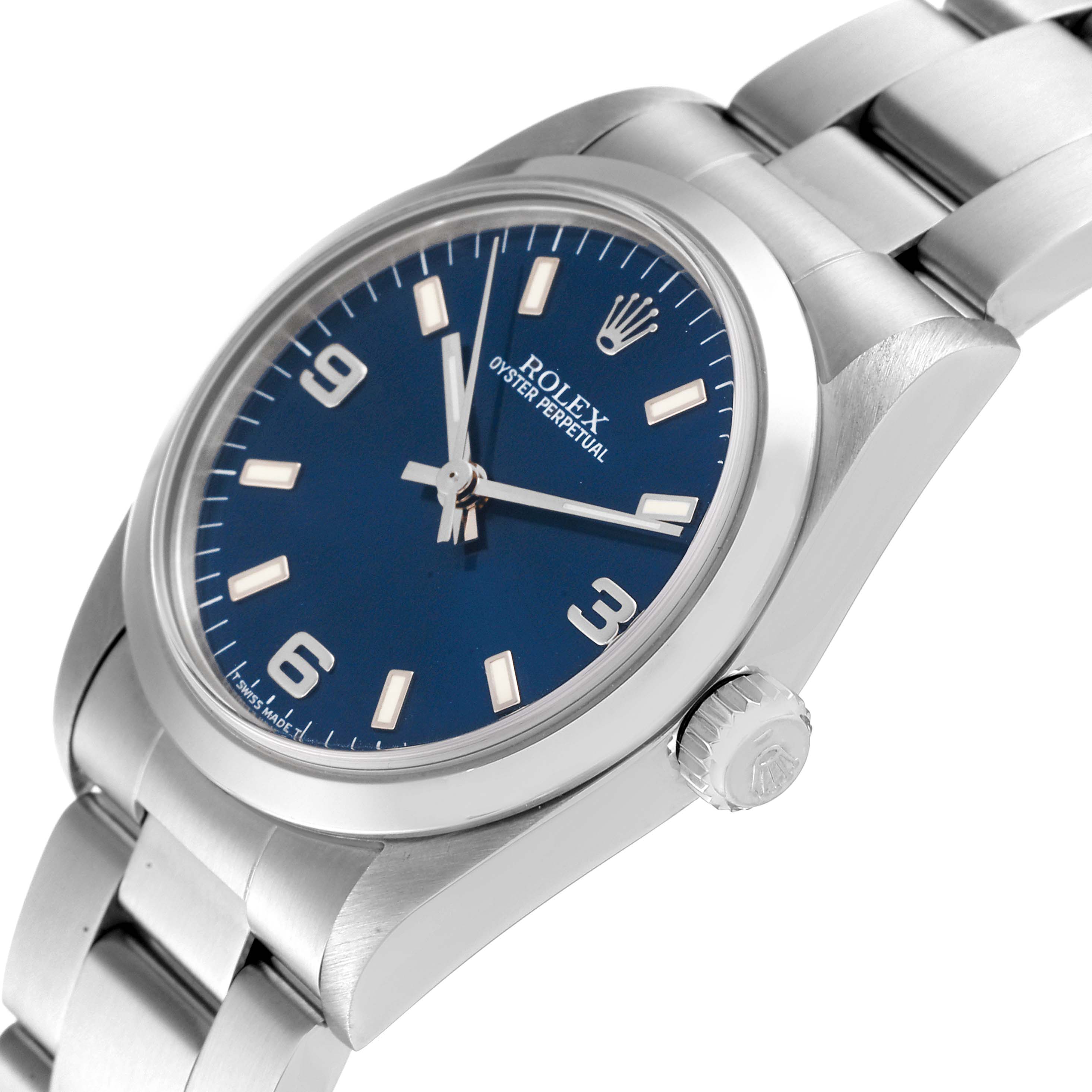 The image shows a side angle view of the Rolex Mid-Size 67480 Women
s Stainless Steel Blue Dial 67480 Women
s Stainless Steel Blue Dial Oyster Perpetual watch, highlighting its blue dial and stainless steel bracelet.
