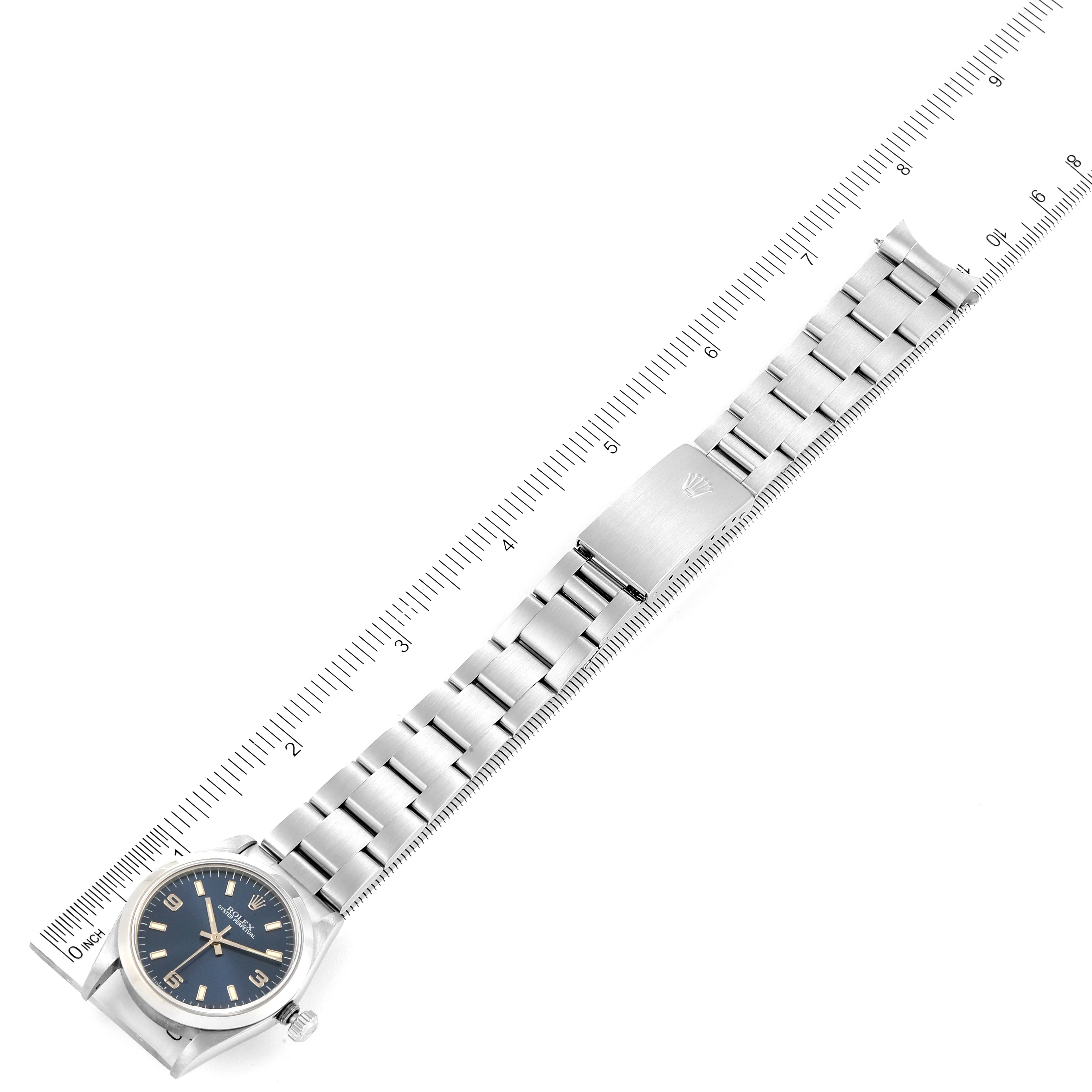 The image shows a full view of a Mid-Size Rolex watch, including its bracelet and clasp, placed next to a ruler for measurements.