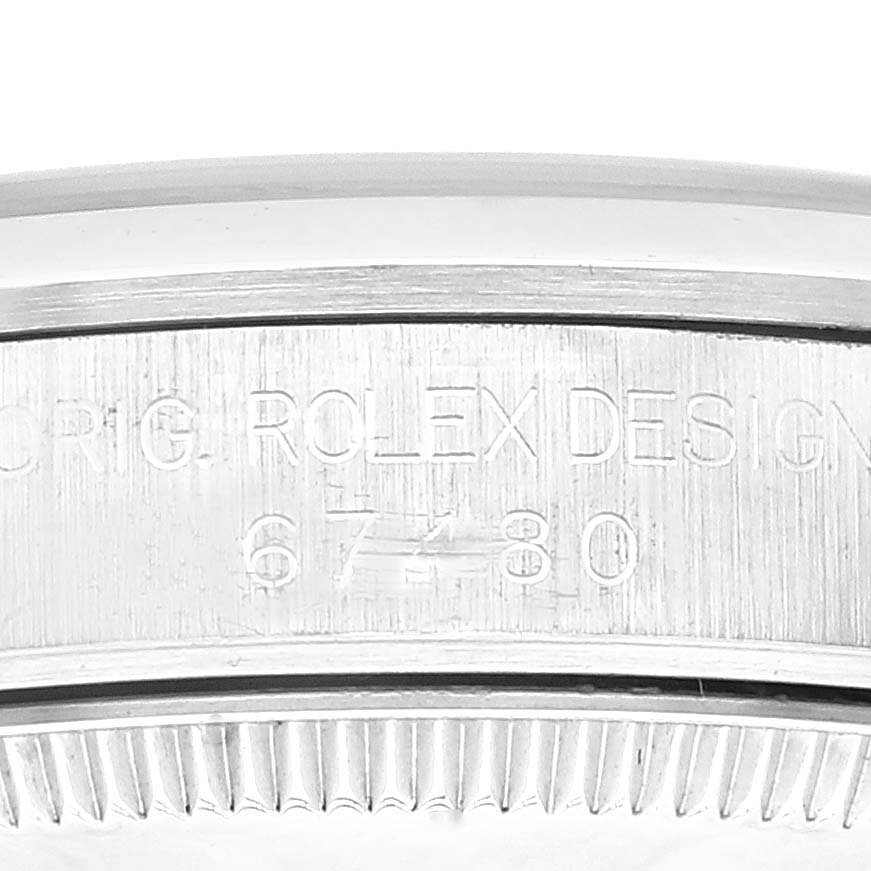 This image shows a close-up of the case side of a Mid-Size Rolex watch, displaying the model and serial number engraving.