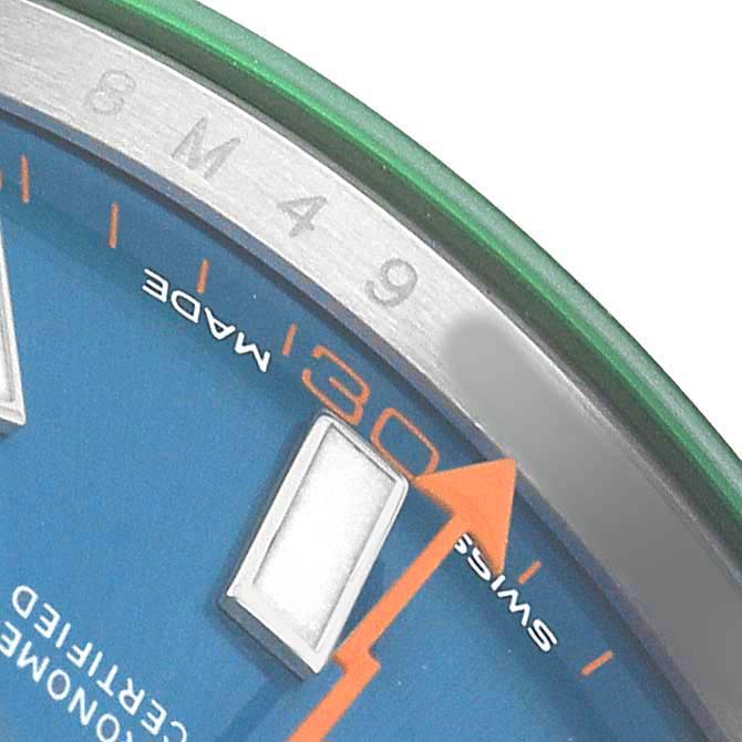 The image shows a close-up of the Rolex Milgauss M116400GV Men's Stainless Steel Blue Dial watch face, highlighting the blue dial, hour marker, and seconds hand.