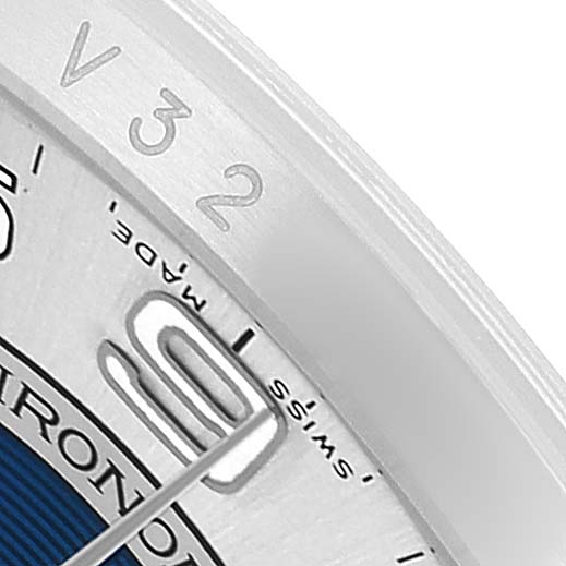 The image shows a close-up of the Rolex Oyster Perpetual 116000 Men's Stainless Steel Silver Dial's bezel and partial dial at an angle, displaying some numerals and "Swiss Made."