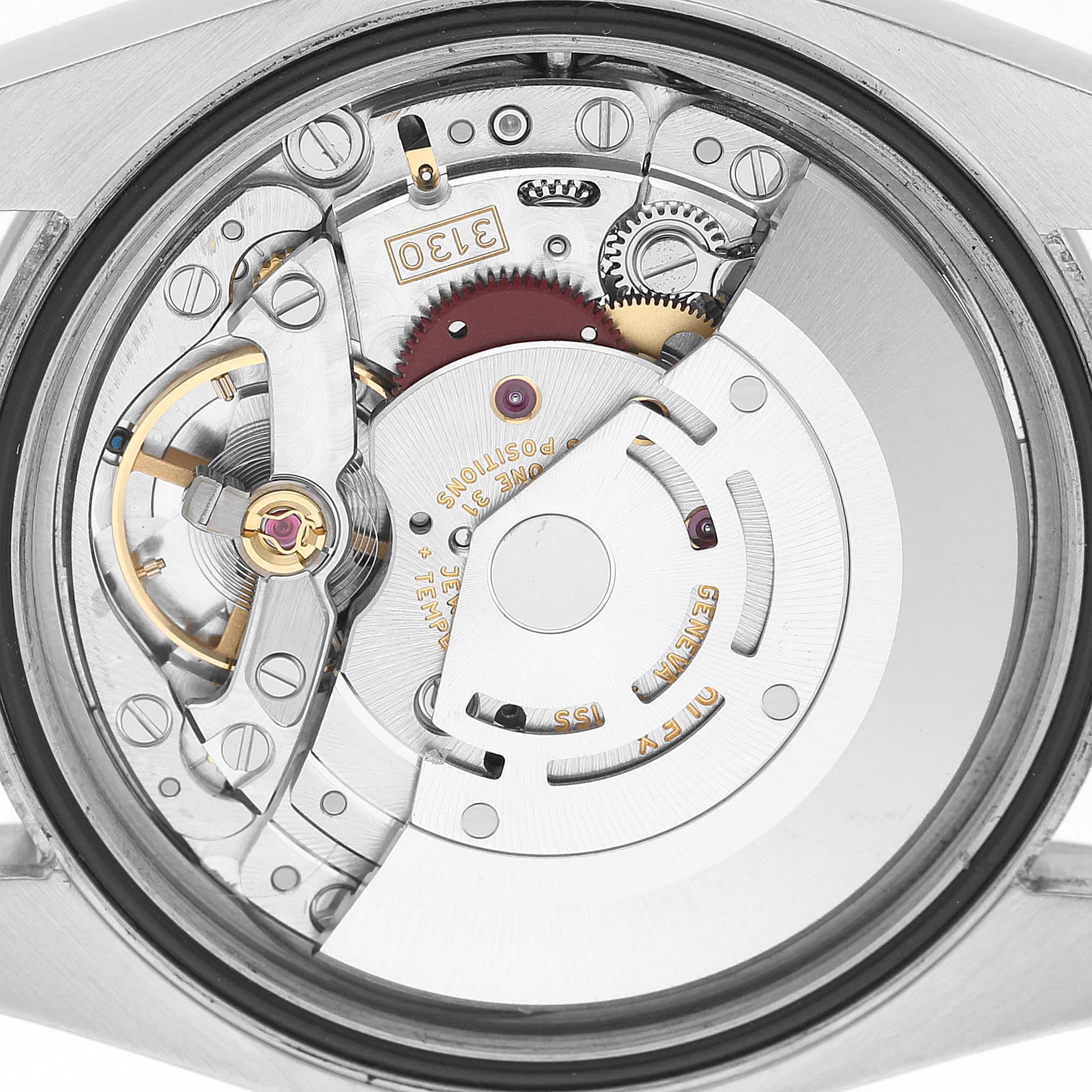 The image shows the movement of a Rolex Oyster Perpetual 116000 Men's Stainless Steel Silver Dial watch from a top-down angle.