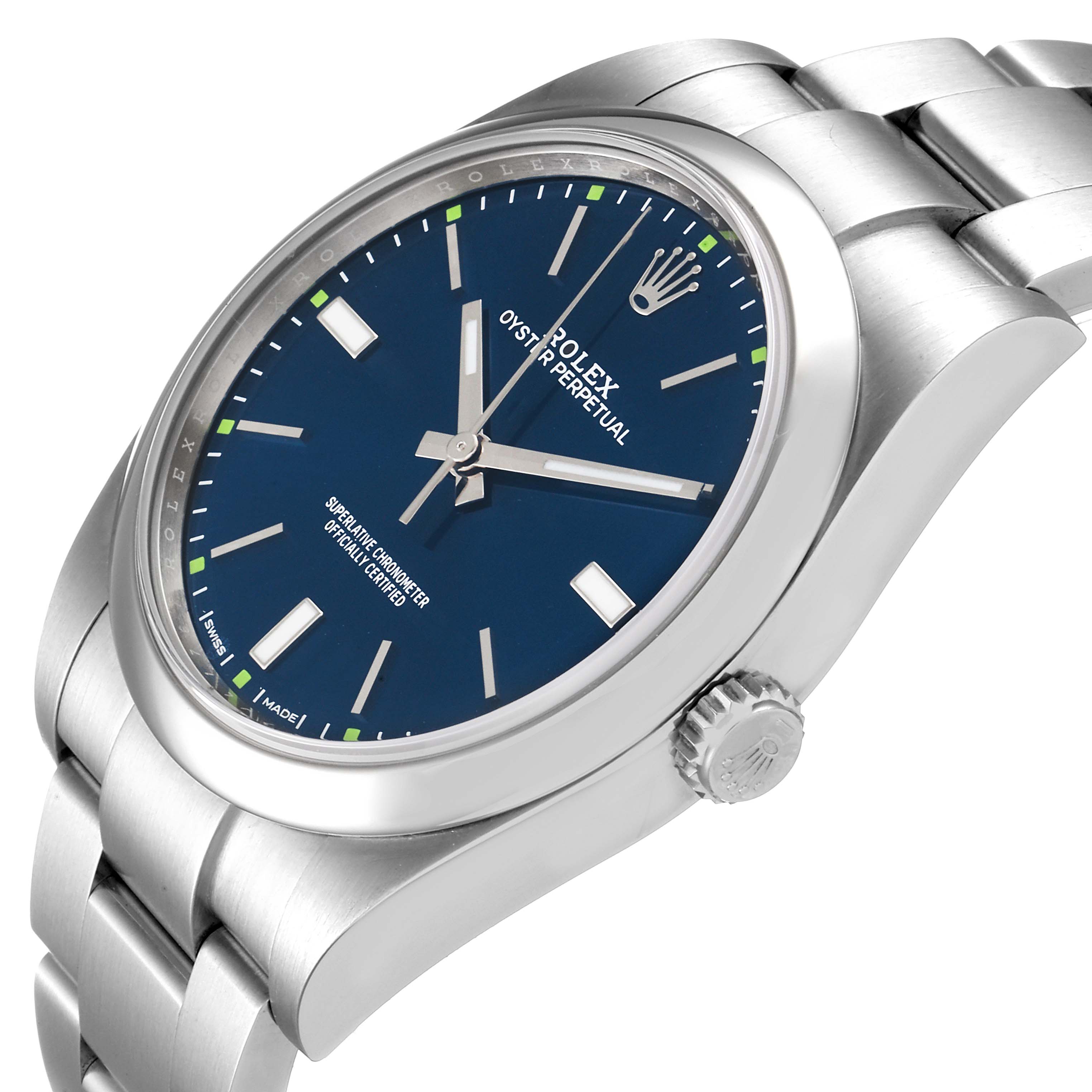 The image shows a Rolex Oyster Perpetual 114300 Men
s Stainless Steel Blue Dial 114300 Men
s Stainless Steel Blue Dial watch at an angled side view, displaying its blue dial, crown, and part of the bracelet.
