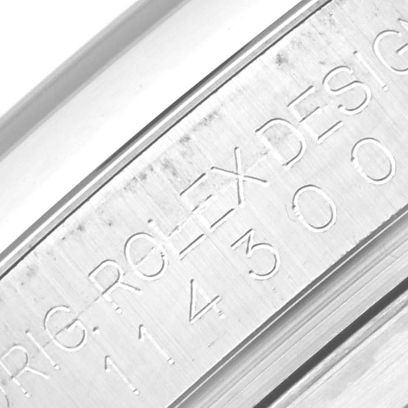 This close-up angle shows the engraved inner bezel of a Rolex Oyster Perpetual 114300 Men
s Stainless Steel Blue Dial 114300 Men
s Stainless Steel Blue Dial watch.