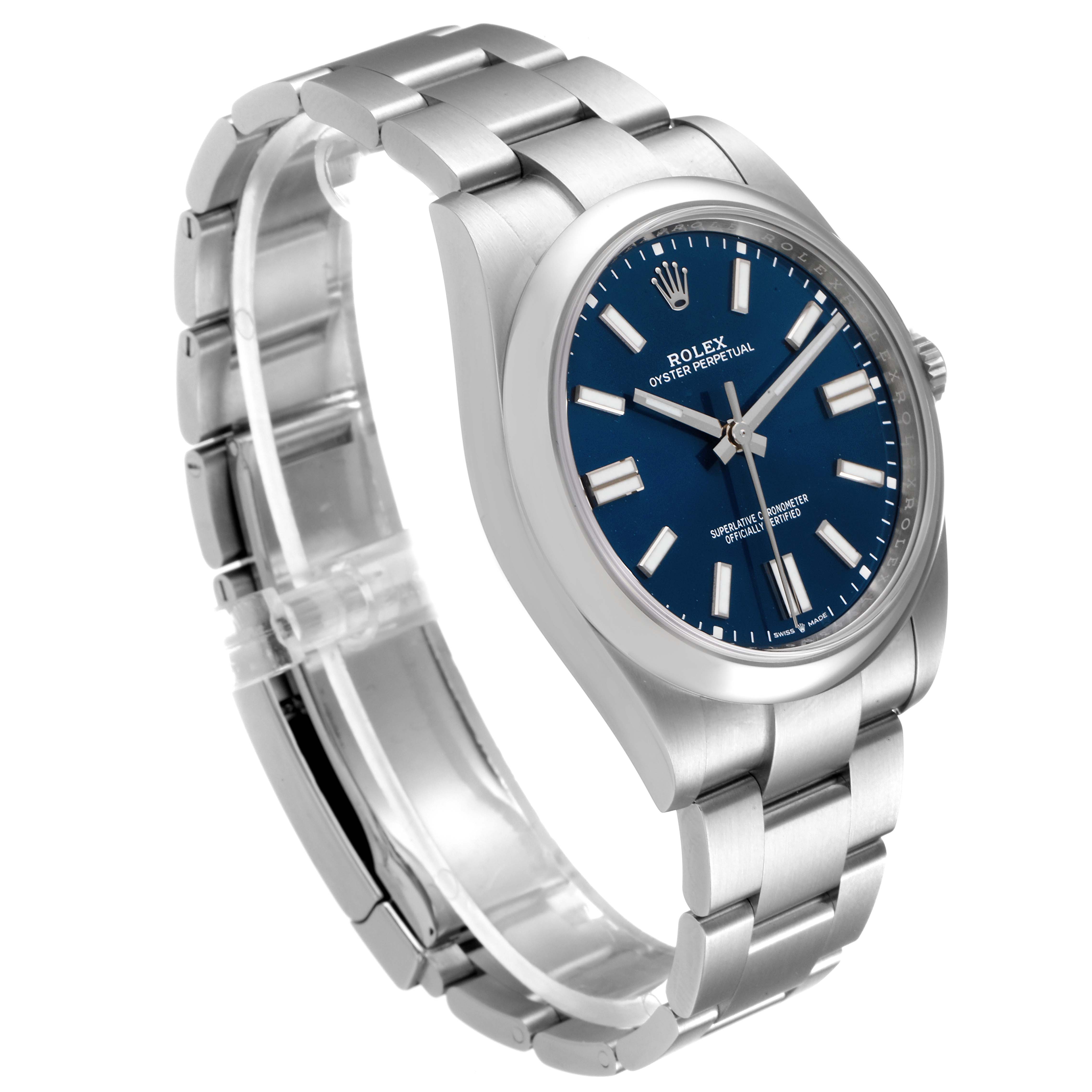 The image shows a Rolex Oyster Perpetual 124300 Men
s Stainless Steel Blue Dial 124300 Men
s Stainless Steel Blue Dial watch at a three-quarter angle, displaying the face, bezel, strap, and clasp.