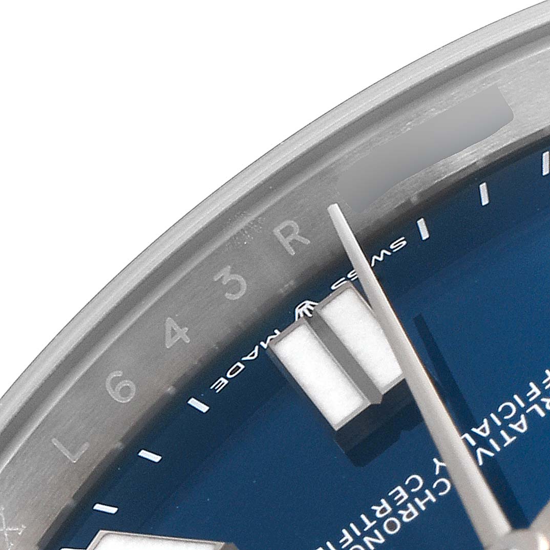 This image shows a close-up of the dial and bezel of a Rolex Oyster Perpetual 124300 Men
s Stainless Steel Blue Dial 124300 Men
s Stainless Steel Blue Dial watch, focusing on the hour markers and minute hand.