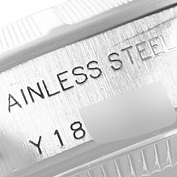 This is a close-up angle of the side of a Rolex Oyster Perpetual 76030 Women
s Stainless Steel Silver Dial 76030 Women
s Stainless Steel Silver Dial watch case, showing "STAINLESS STEEL" engraved on it.