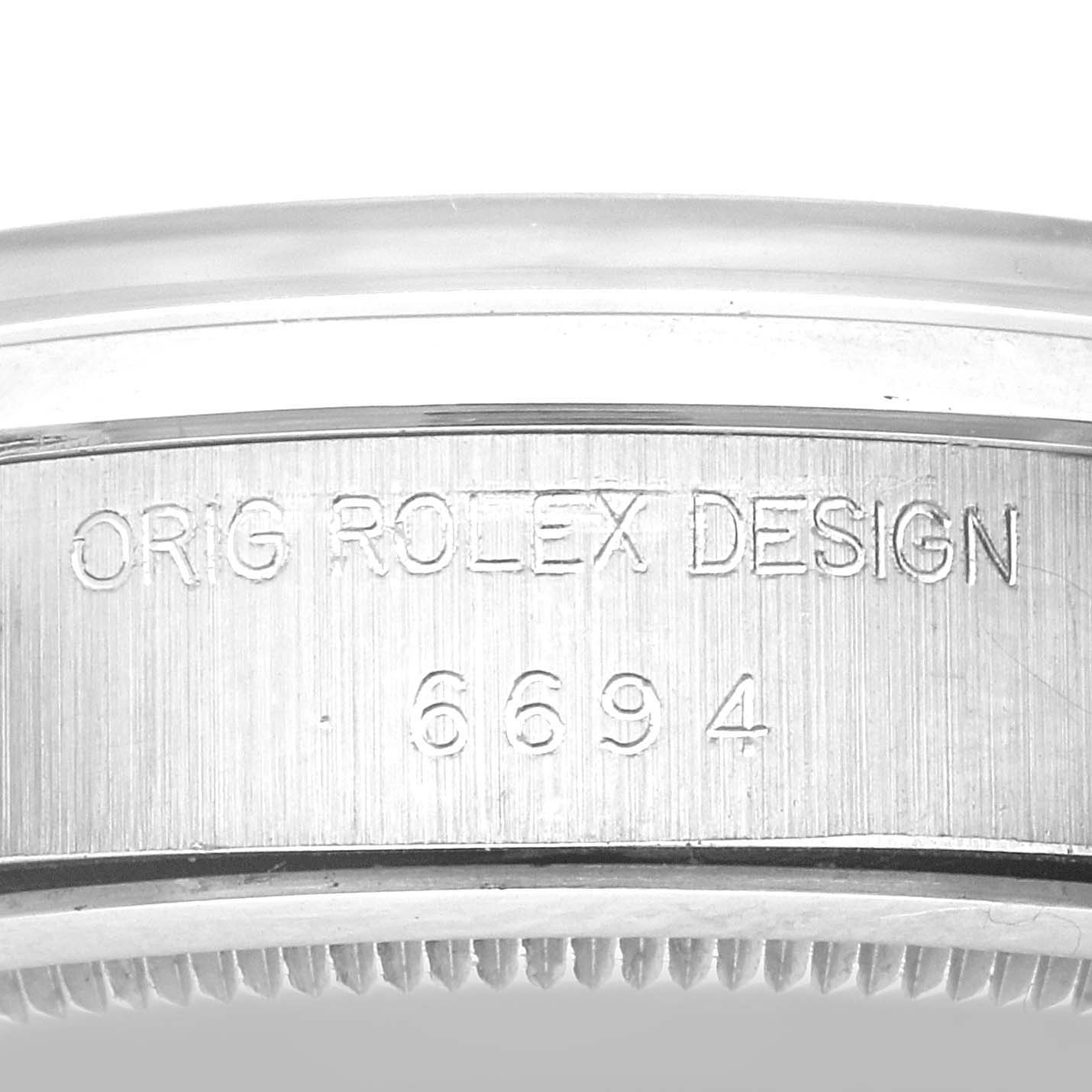 The image shows a close-up of the case side of a Vintage Collection Rolex watch, featuring the engraved text "ORIG ROLEX DESIGN 6694."
