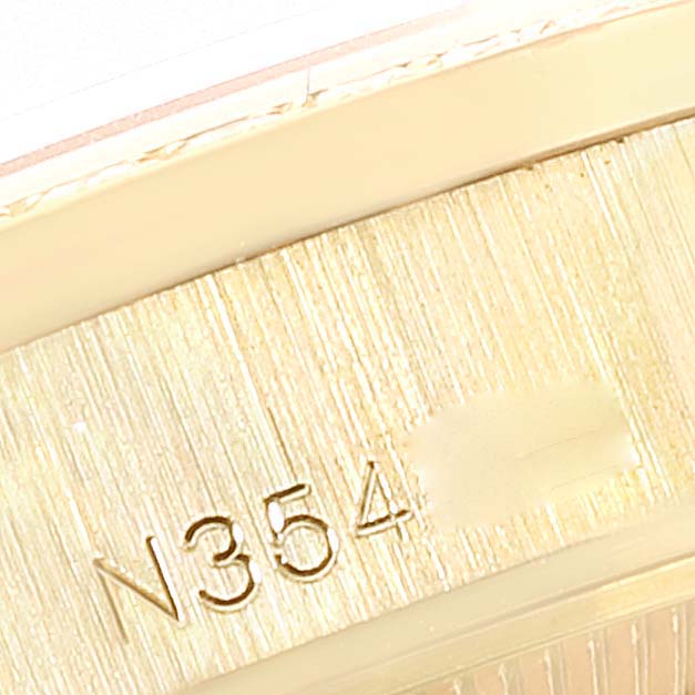 This close-up image shows the side engraving and part of the bezel of a Rolex President 69158 Women
s Yellow Gold Champagne Dial 69158 Women
s Yellow Gold Champagne Dial model watch.