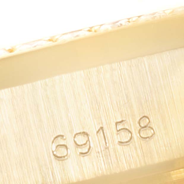 This close-up image shows the engraved model number "69158" on the side of a Rolex President 69158 Women
s Yellow Gold Champagne Dial 69158 Women
s Yellow Gold Champagne Dial watch case.