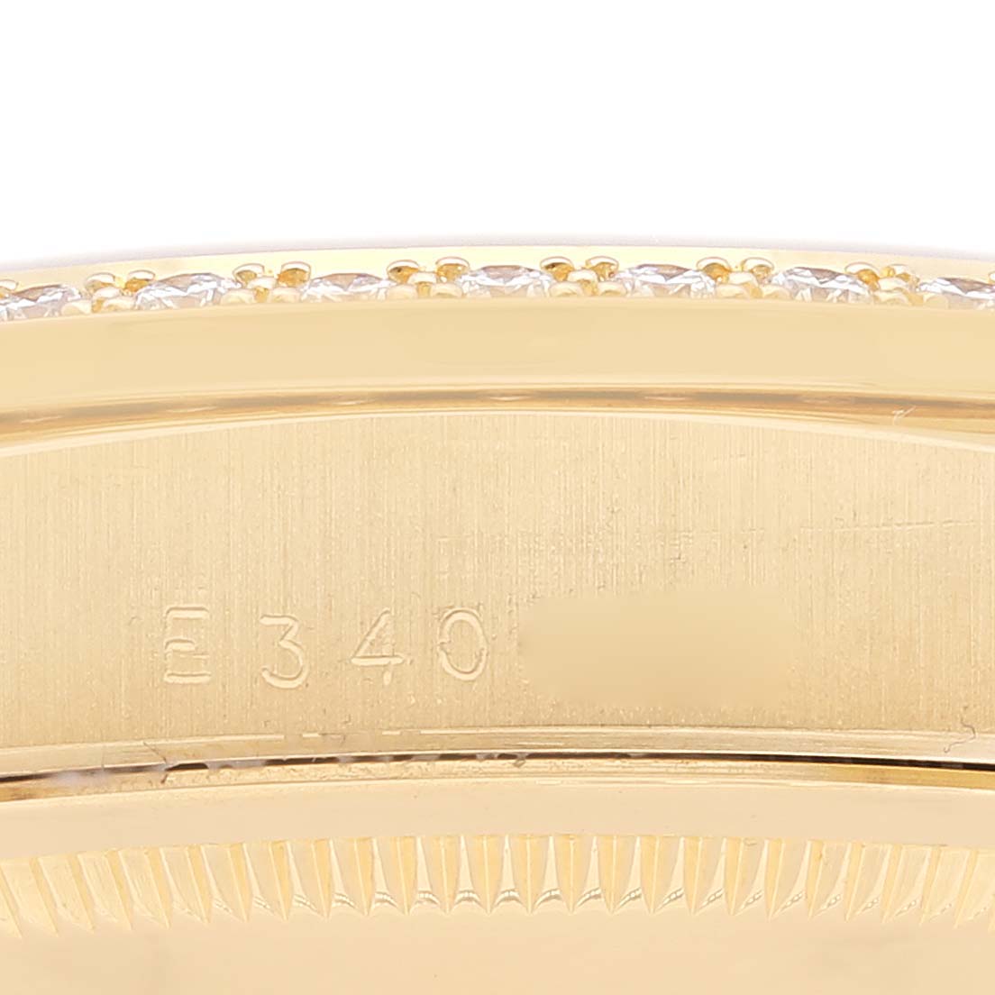 The image shows a close-up of the bezel and serial number on the side of a gold Rolex President 18348 Men
s Yellow Gold Champagne Dial 18348 Men
s Yellow Gold Champagne Dial model watch.
